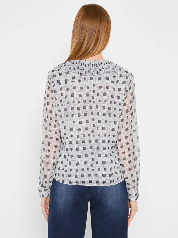 Nic & Zoe Dotty Ruffles Blouse, stylish women's top with ruffle details and playful dot pattern, displayed on a hanger.