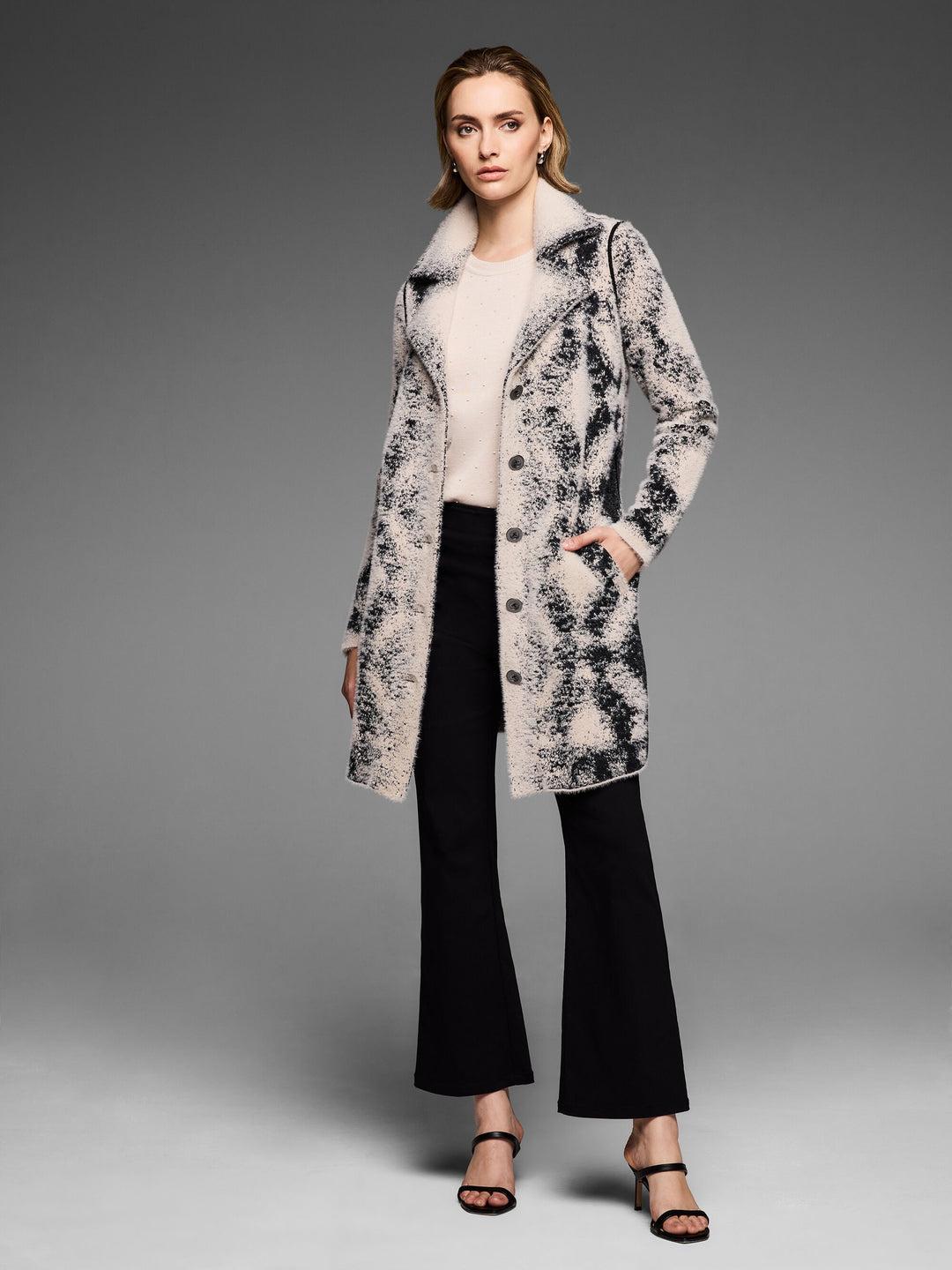 Textured diamond-patterned Nic & Zoe top displayed on a hanger, showcasing the stylish and detailed fabric design.