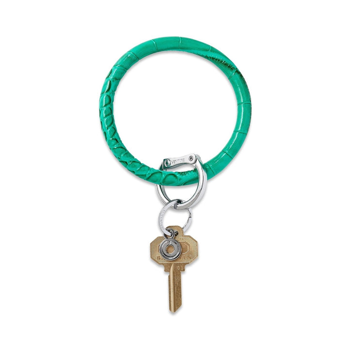 O-venture leather key ring with "O" ring design, featuring a sleek leather strap and metal keyring for stylish key organization.