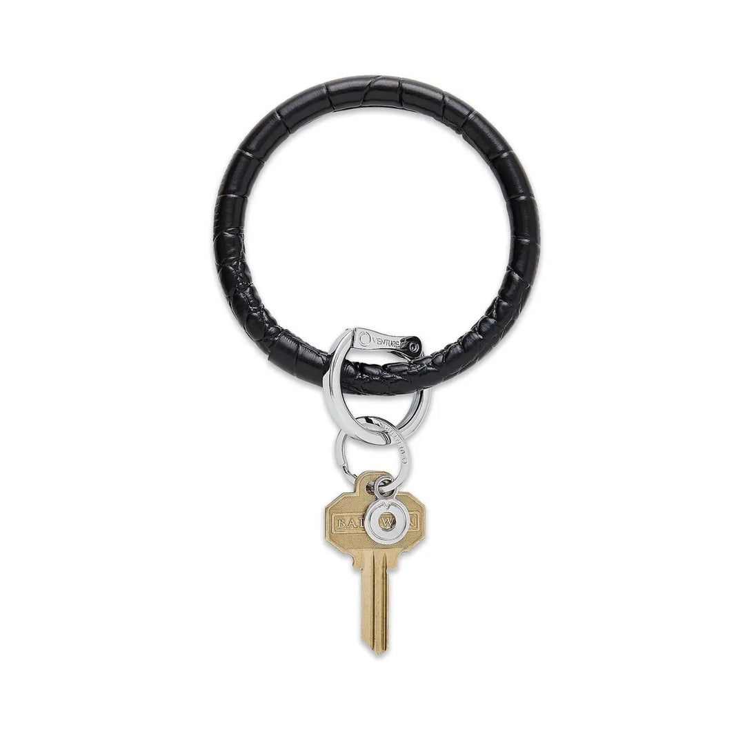 O-venture leather "O" ring key ring with engraved "O" logo, designed for holding keys and accessories.