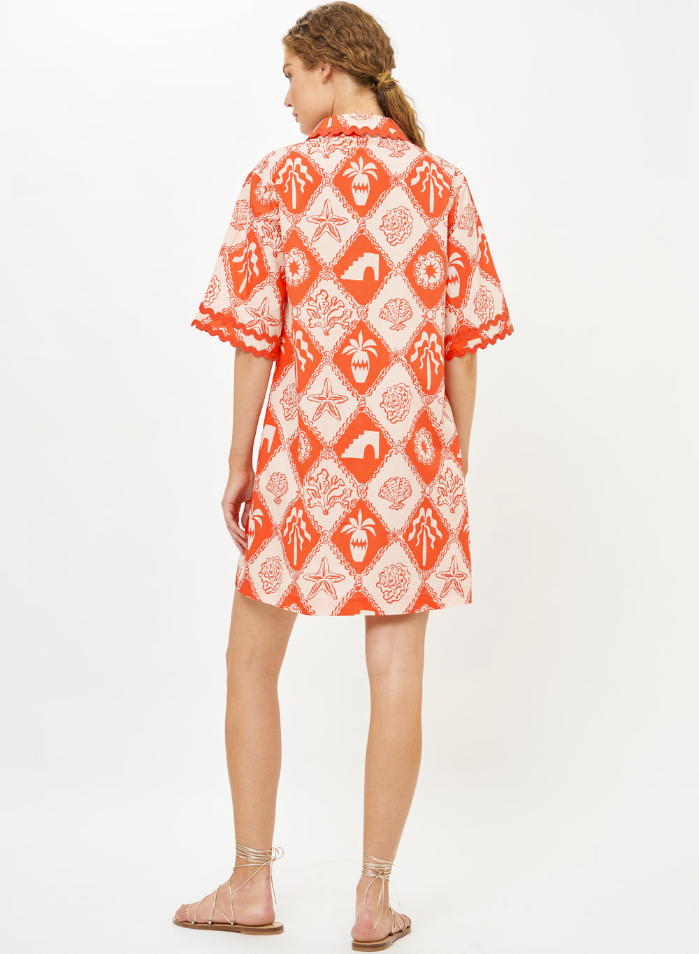 Oliphant Asterias red collared shirt dress hanging on a wooden hanger, featuring long sleeves and a button-down front.