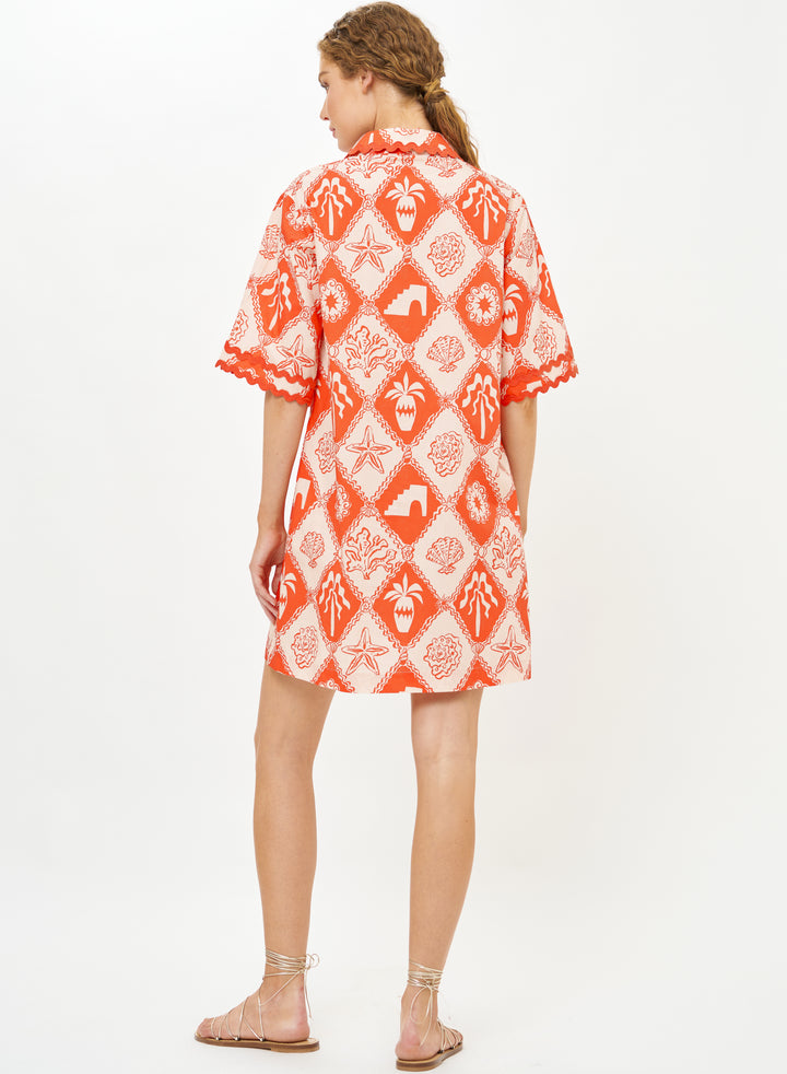 Oliphant Asterias red collared shirt dress hanging on a wooden hanger, featuring long sleeves and a button-down front.