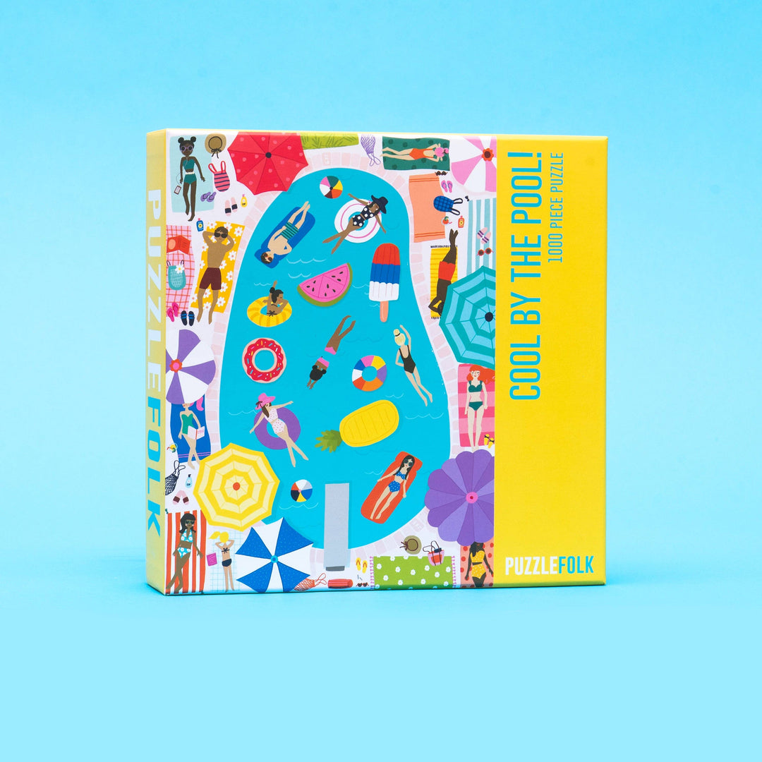 Colorful gift box from Puzzlefolk's "Cool By The Pool" collection, featuring vibrant summer-themed illustrations on a gift package.