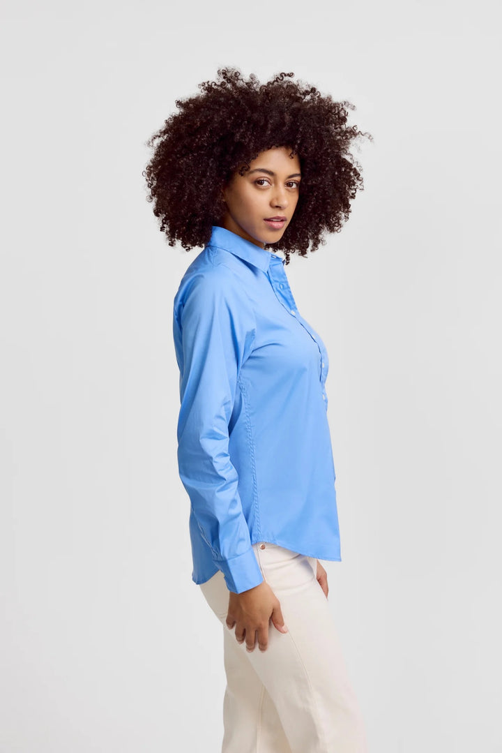French Blue Icon Shirt by Rochelle Behrens, stylish tops featuring a vibrant blue color and classic design, shown on a model.