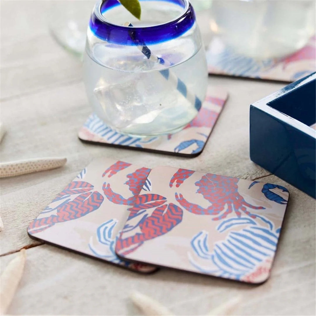 Set of four Rockflowerpaper home coasters with colorful, artistic designs on a smooth surface, perfect for protecting tables.