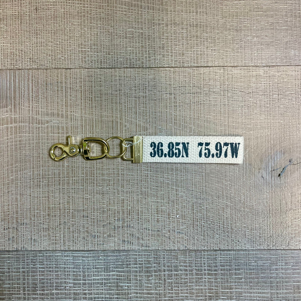Rustic Marlin local gift key fobs featuring personalized designs and keyring attachments on a neutral background.