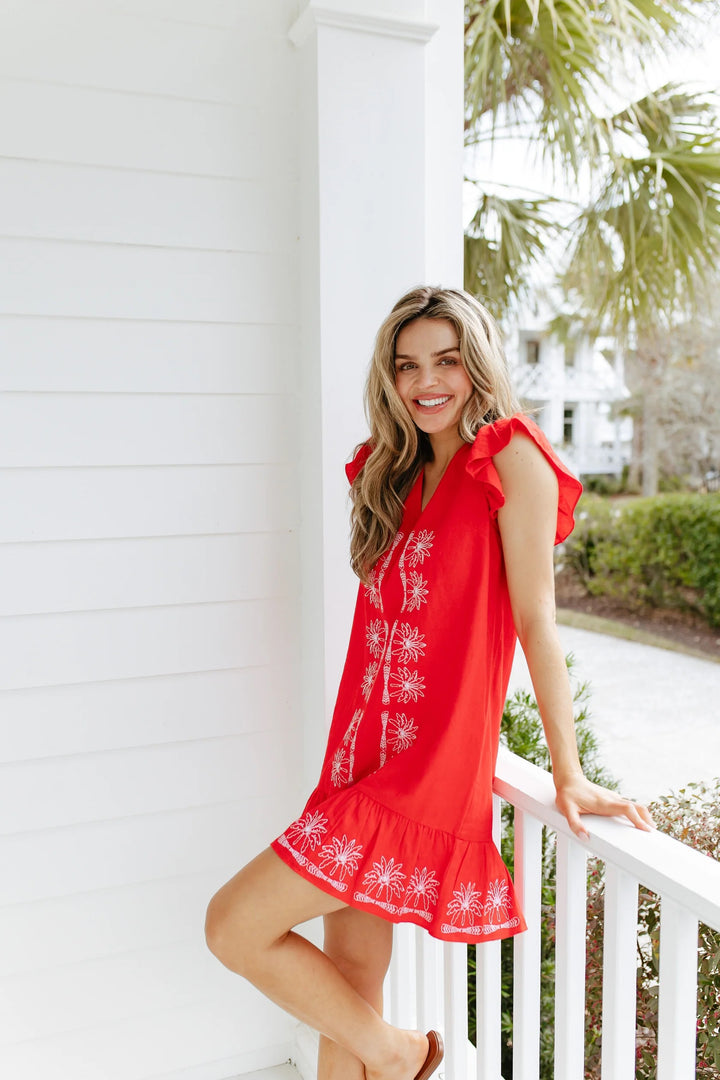 Sail to Sable Flame V-neck ruffle dress with short sleeves, flowing silhouette, and feminine ruffle details on the hem.