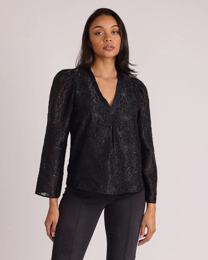 Sedge Jolie Onyx Floral Blouse featuring a black background with colorful floral print, long sleeves, and a relaxed fit.