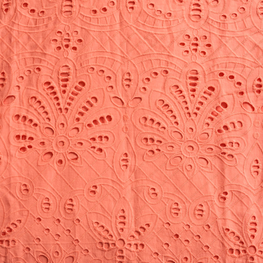 Sheridan French Miller Melon eyelet dress with short sleeves and a fitted bodice, showcased on a hanger.