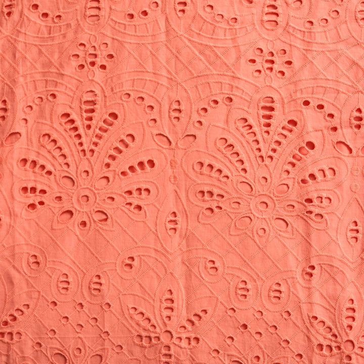 Sheridan French Miller Melon eyelet dress with short sleeves and a fitted bodice, showcased on a hanger.