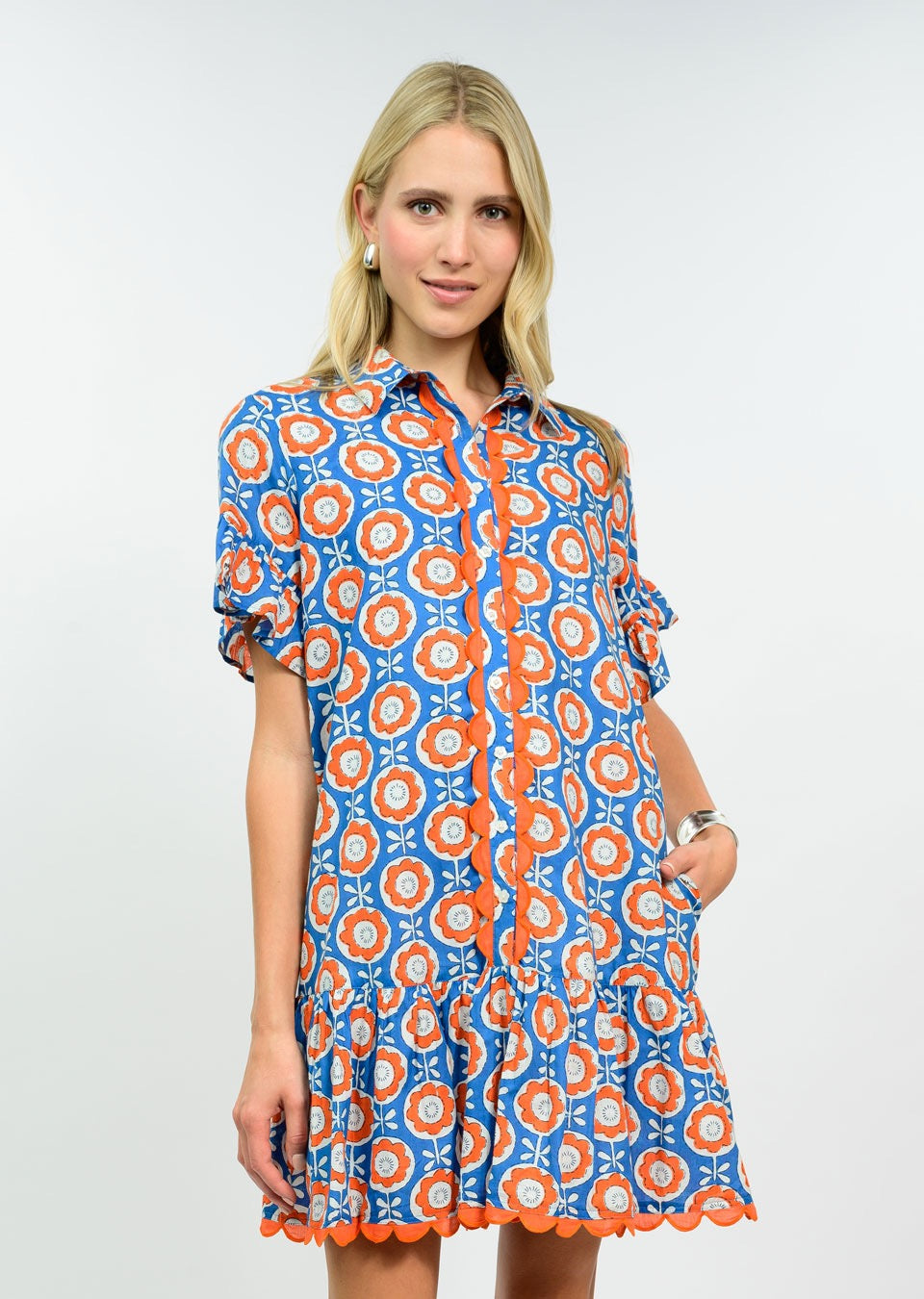 Sister Mary Daisy scallop trim dress featuring a floral pattern, sleeveless design, and a fitted waist on a model.