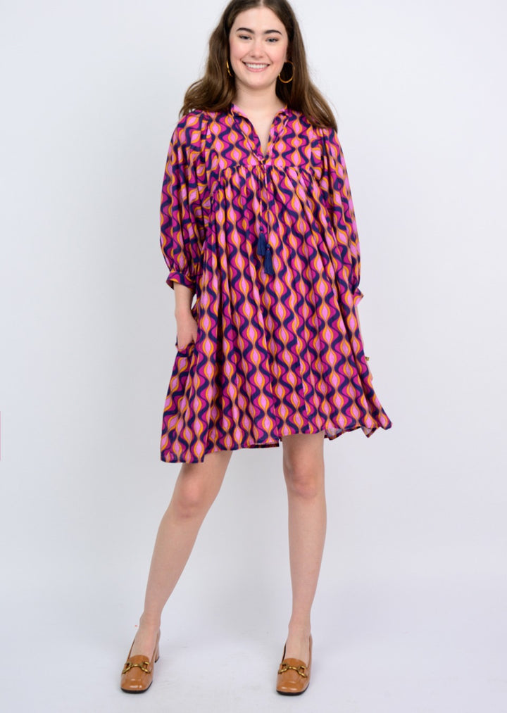 Sister Mary Mod Multi Dress displayed on a hanger, showcasing its colorful, patterned design and casual style.