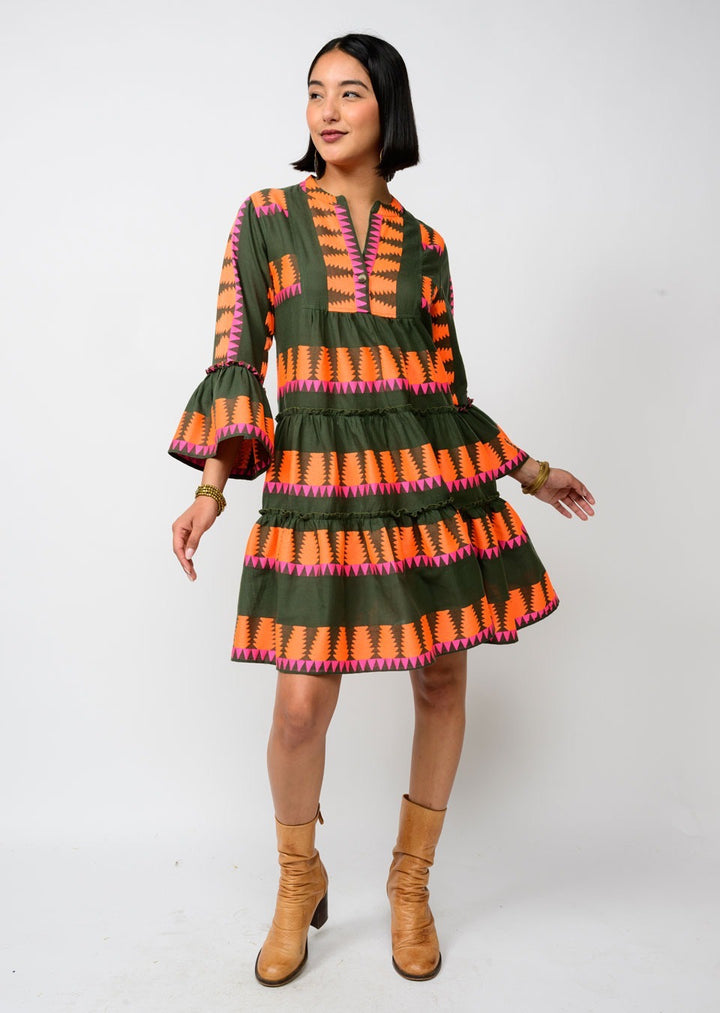 Olive Sister Mary Jacquard Tier Dress displayed on a hanger with intricate fabric pattern and layered design.