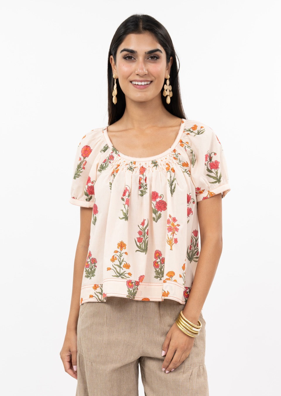 Sister Mary smocked bloom top with ruffled neckline and floral print, stylish women's blouse on a neutral background.