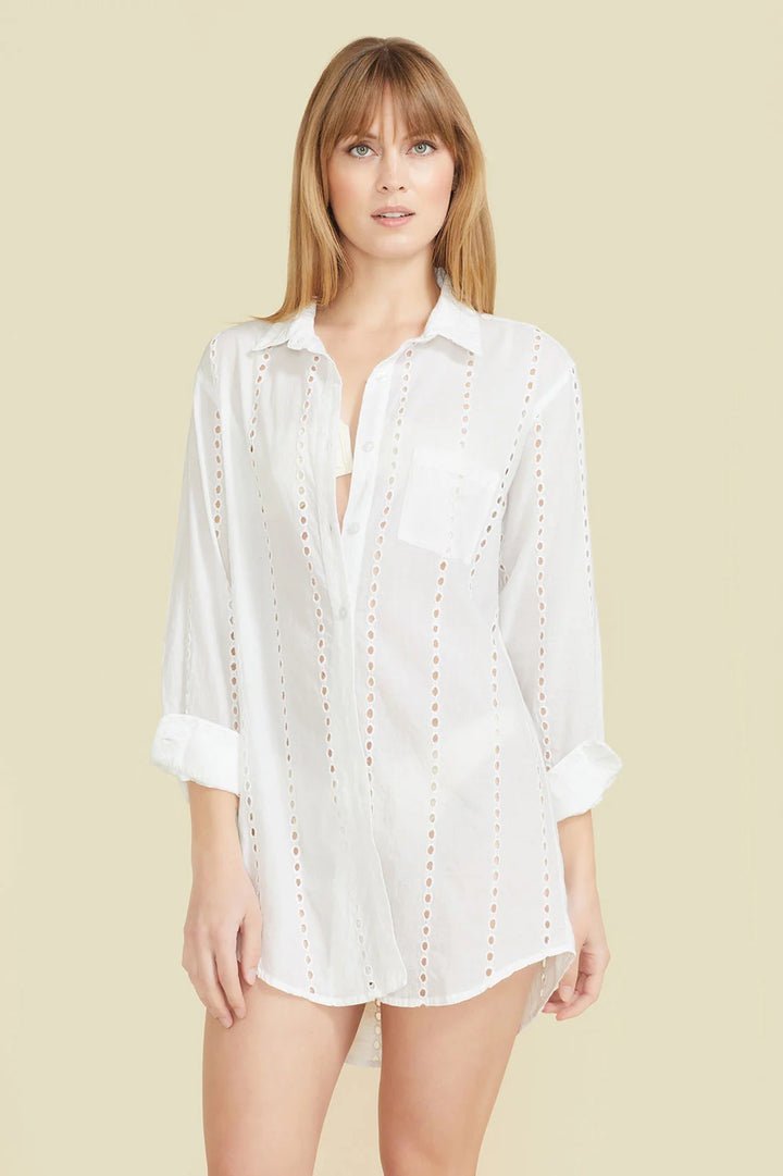 Sitano Positano white shirtdress hanging on a wooden hanger, showcasing its relaxed fit and classic collar style.