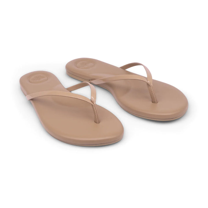 Pair of stylish Solei Sandals accessories featuring tan straps and flat soles, perfect for casual summer outfits.