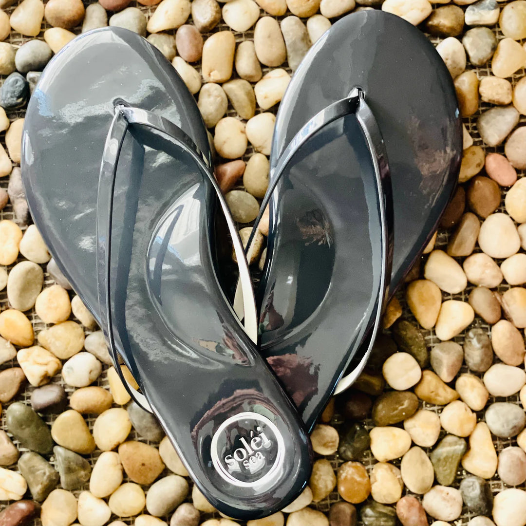 Solei Sandals flip flops with tan straps and cushioned soles, suitable for casual summer wear.