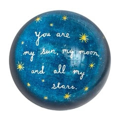 Decorative round paperweight from Sugarboo Designs featuring a 4x4 inch gift-themed design with artistic details.
