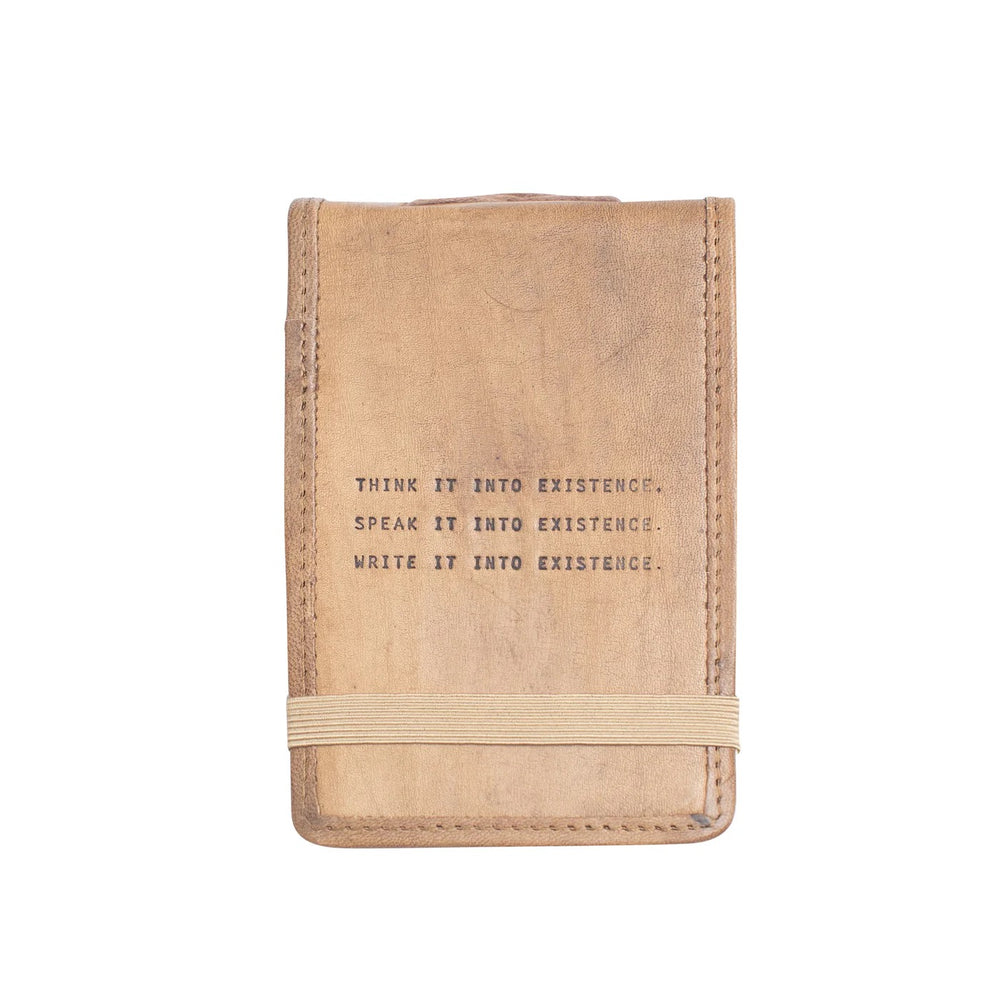 Mini leather journal by Sugarboo Designs, showing a rustic brown leather cover with delicate embossed details.