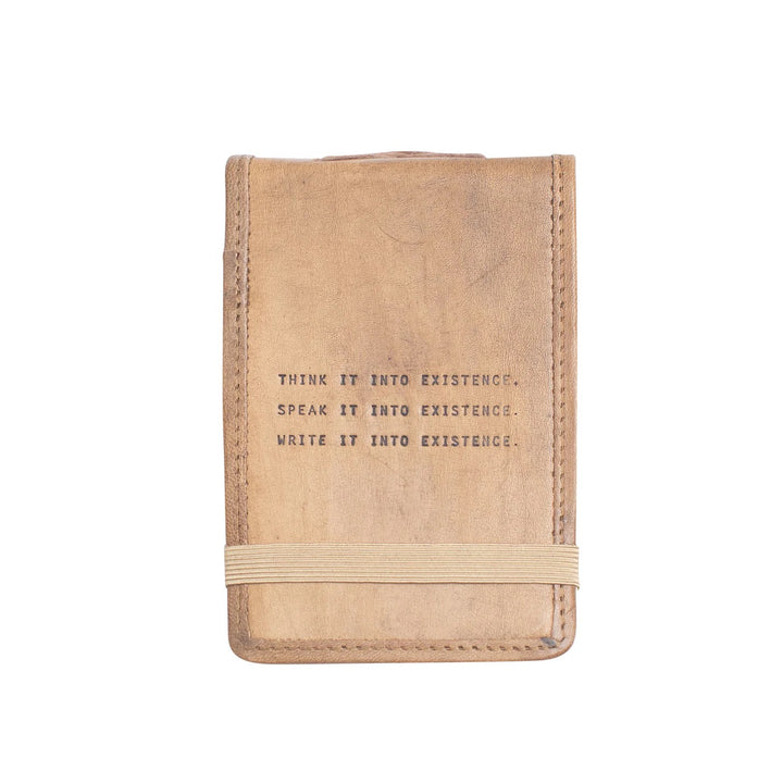 Mini leather journal by Sugarboo Designs, showing a rustic brown leather cover with delicate embossed details.
