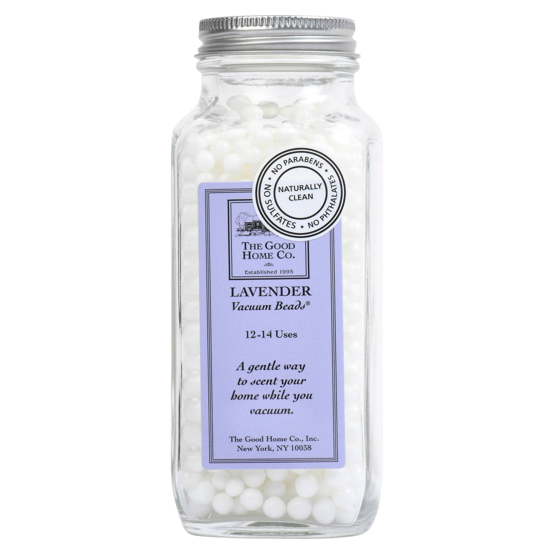 Close-up of Good Home Vacuum Beads in a clear container, showing their small round shape and light color for home cleaning.