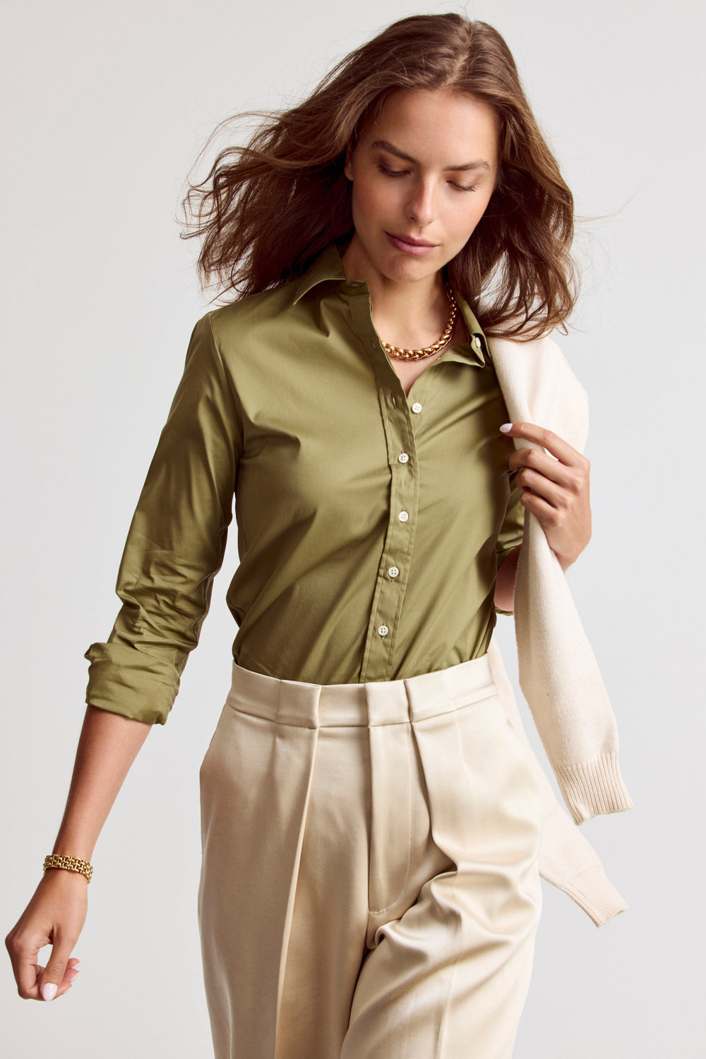 Olive Rochelle Behrens Icon Shirt, a stylish women's top with a relaxed fit and classic collar, displayed on a hanger.