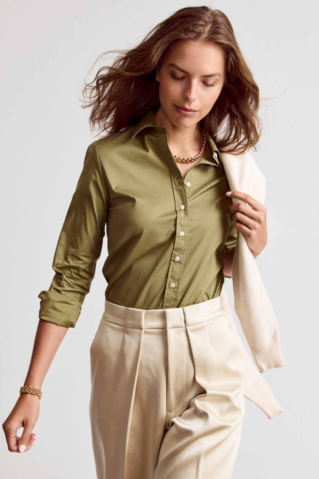 Olive Rochelle Behrens Icon Shirt, a stylish women's top with a relaxed fit and classic collar, displayed on a hanger.
