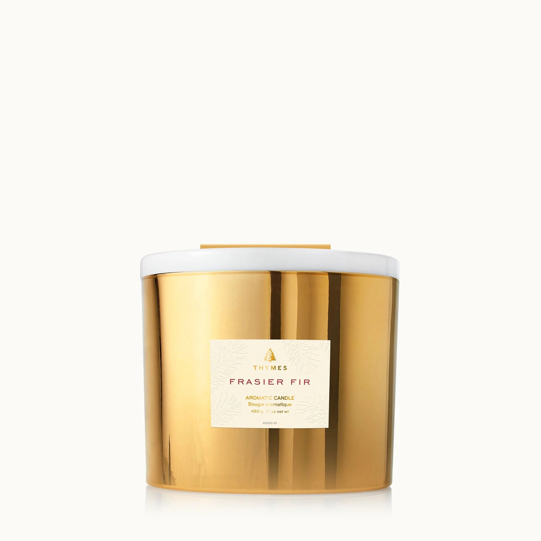Thymes Frasier Fir Gold 3-wick candle with a festive green and gold design, ideal for home decor and holiday ambiance