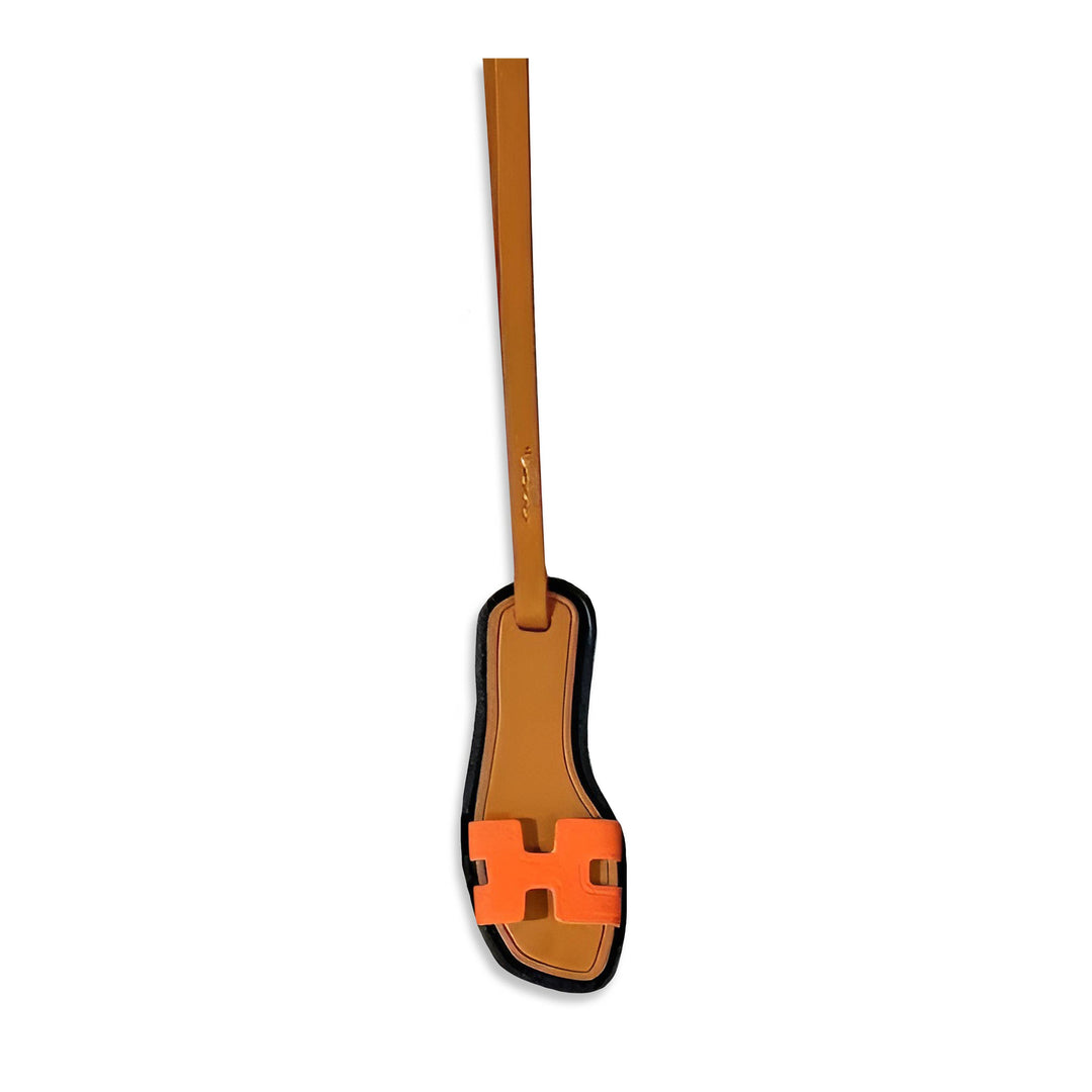 Bright orange sandal bag charm from Toss Designs accessories, featuring a detailed sandal design perfect for decorating bags.