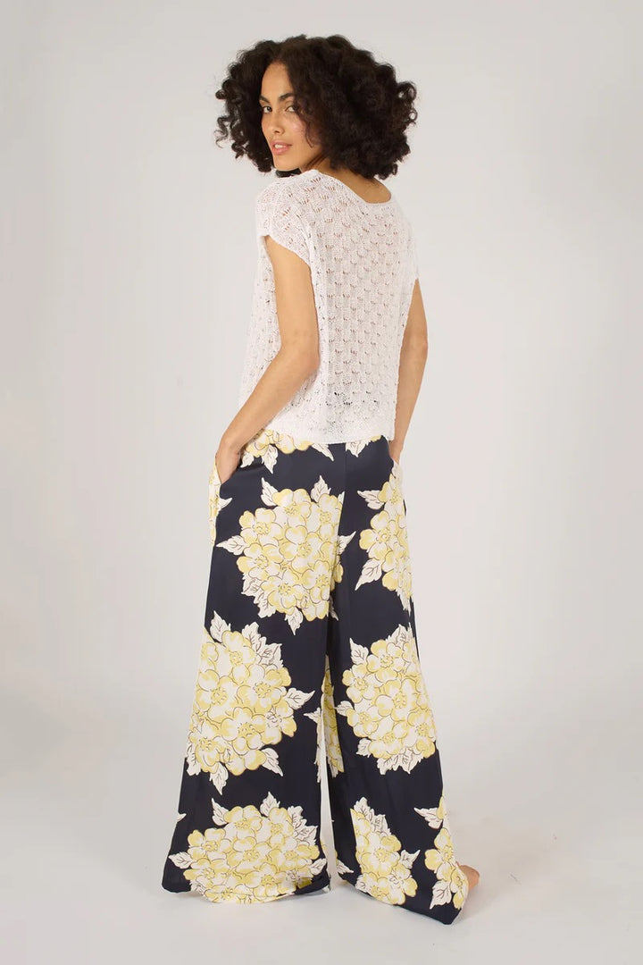 Traffic People Blooming Lovely trousers, stylish bottoms with a floral pattern, shown on a model against a neutral background.