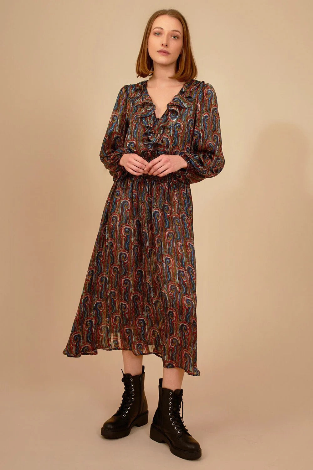 Traffic People Ballard Dress displayed on a hanger with floral pattern and flowing fabric.