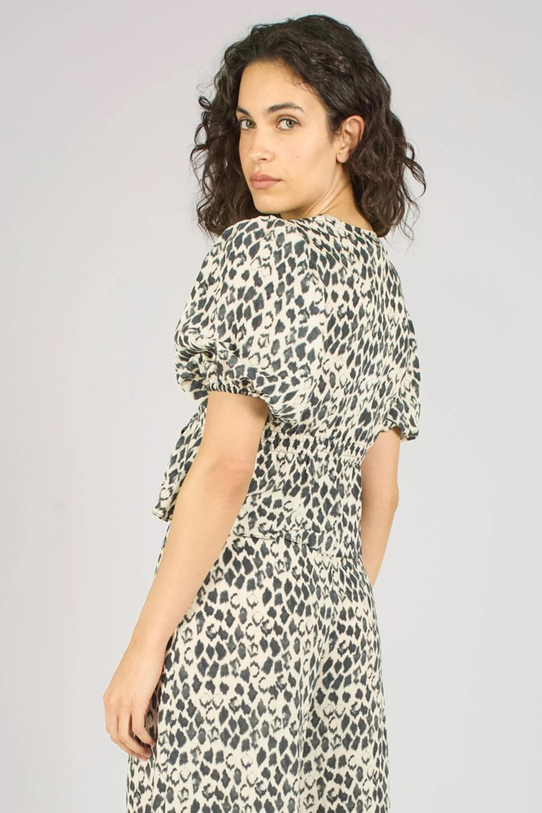Traffic People Margot black print top, stylish women’s tops with bold print and relaxed fit, shown on a hanger.