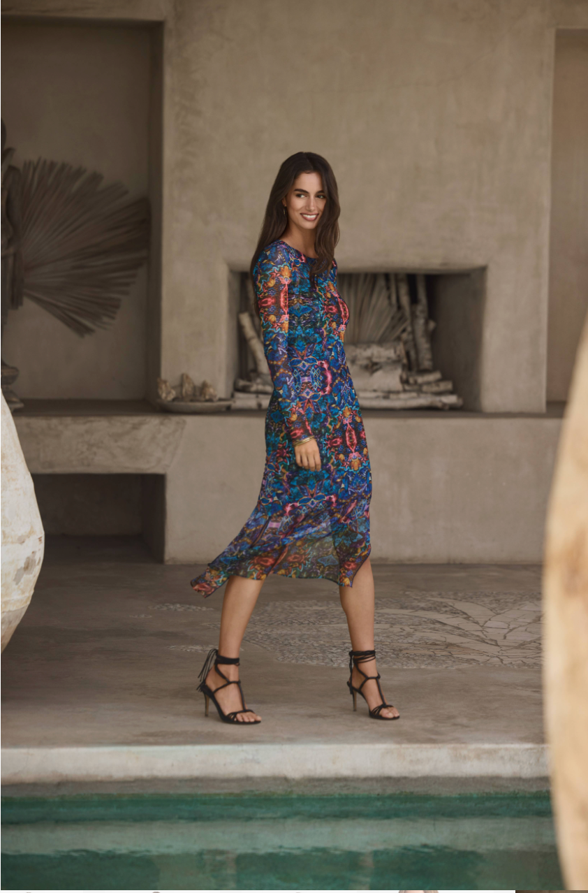 woman next to pool in colorful midi dress