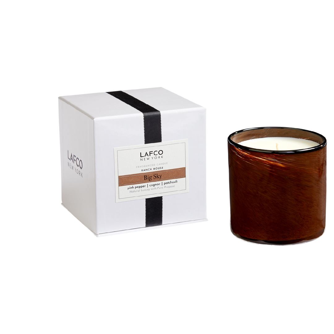 Lafco 15.5oz home candle with a sleek glass container, elegant design, and a lit wick for cozy ambiance.