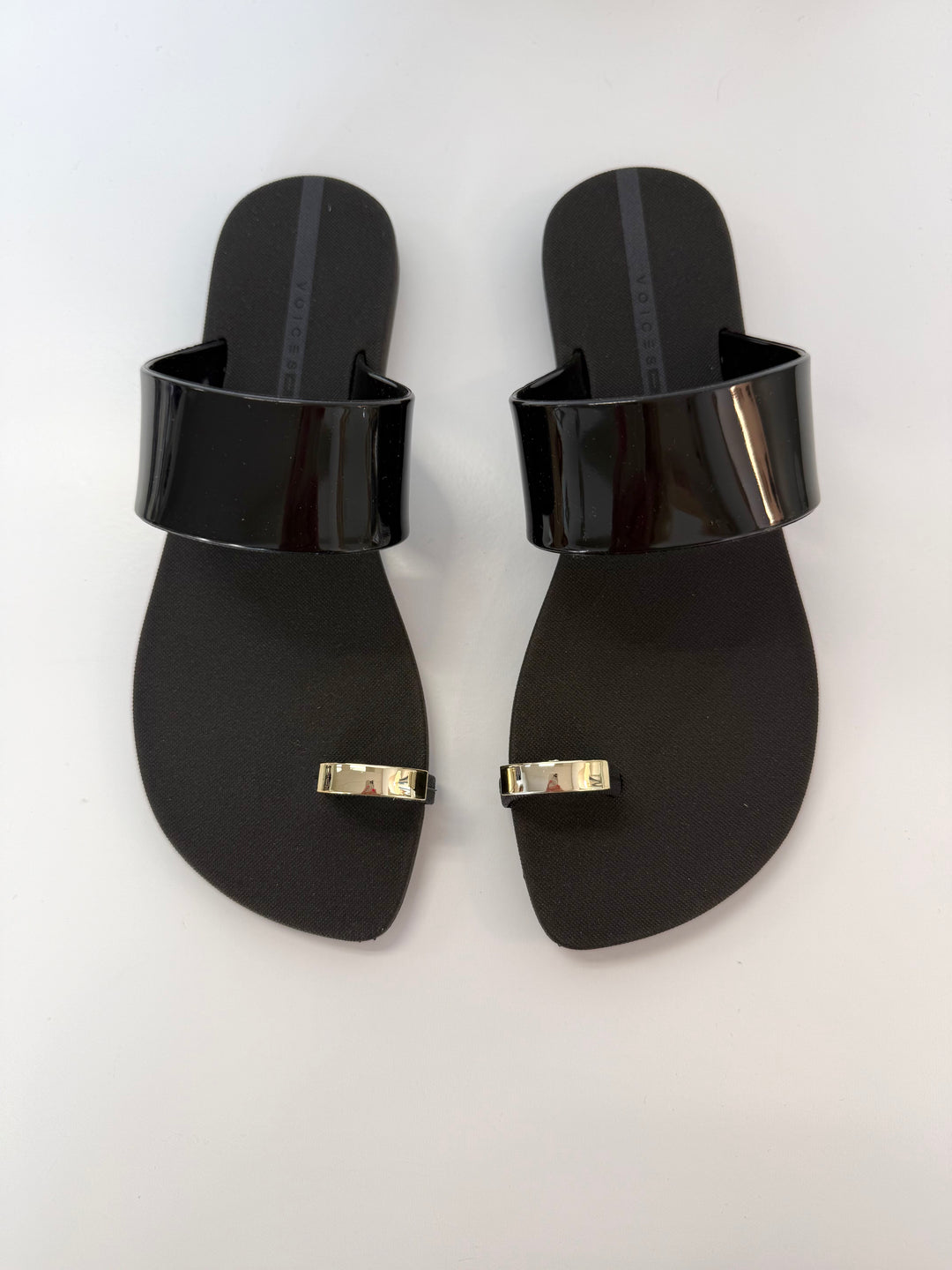 Voices Anello black and gold sandal, stylish accessories with sleek straps and metallic accents, designed for casual wear.