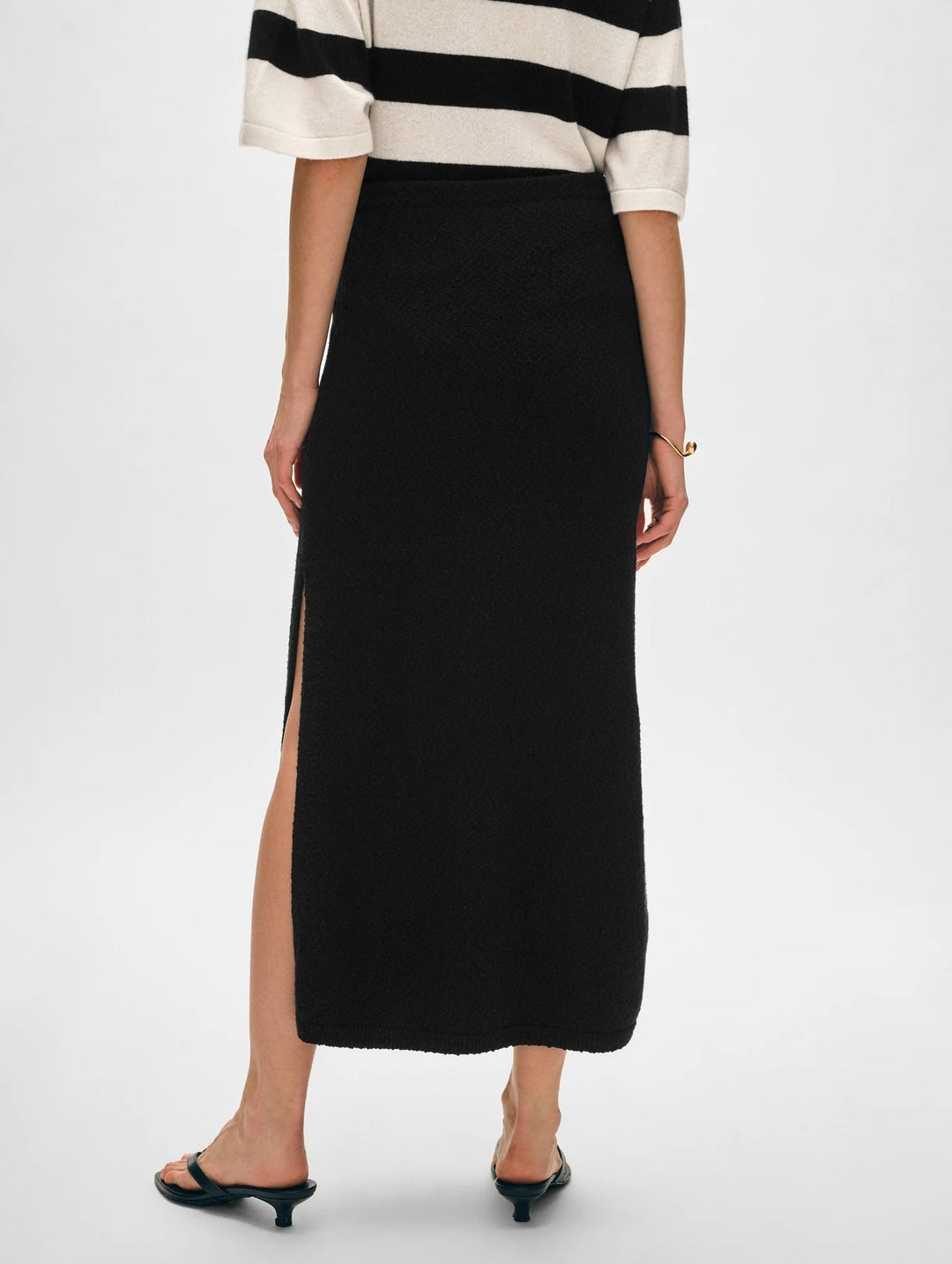 White & Warren cotton slub slit skirt, lightweight bottoms with side slit, styled on a model against a neutral background.