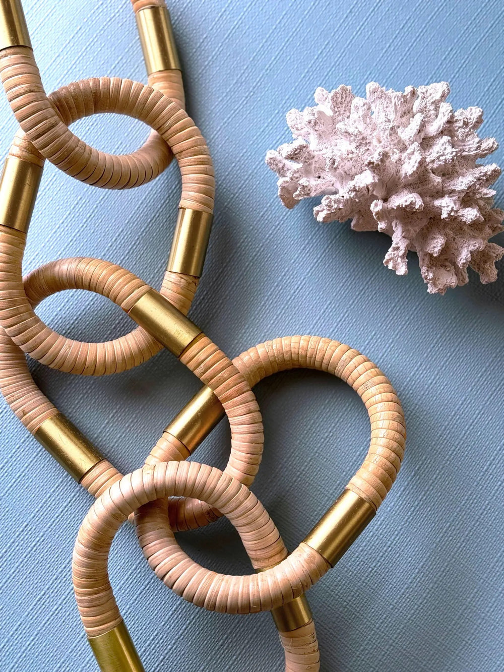 Oval rattan decorative chain for home decor by Worlds Away, showcasing woven rattan links in a stylish design.