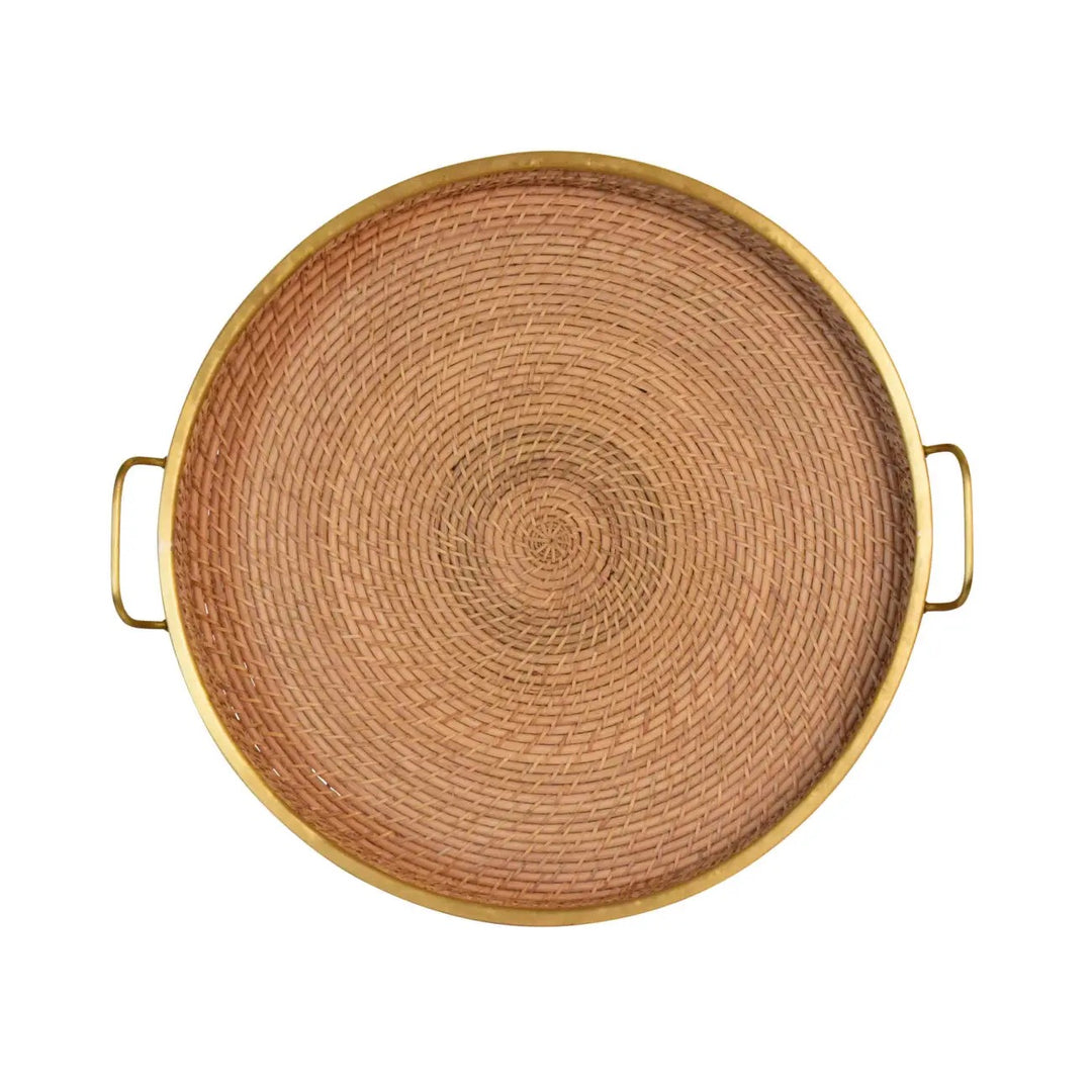 Round rattan and brass tray for home decor, featuring a stylish design with natural rattan and shiny brass accents.