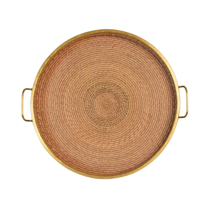 Round rattan and brass tray for home decor, featuring a stylish design with natural rattan and shiny brass accents.