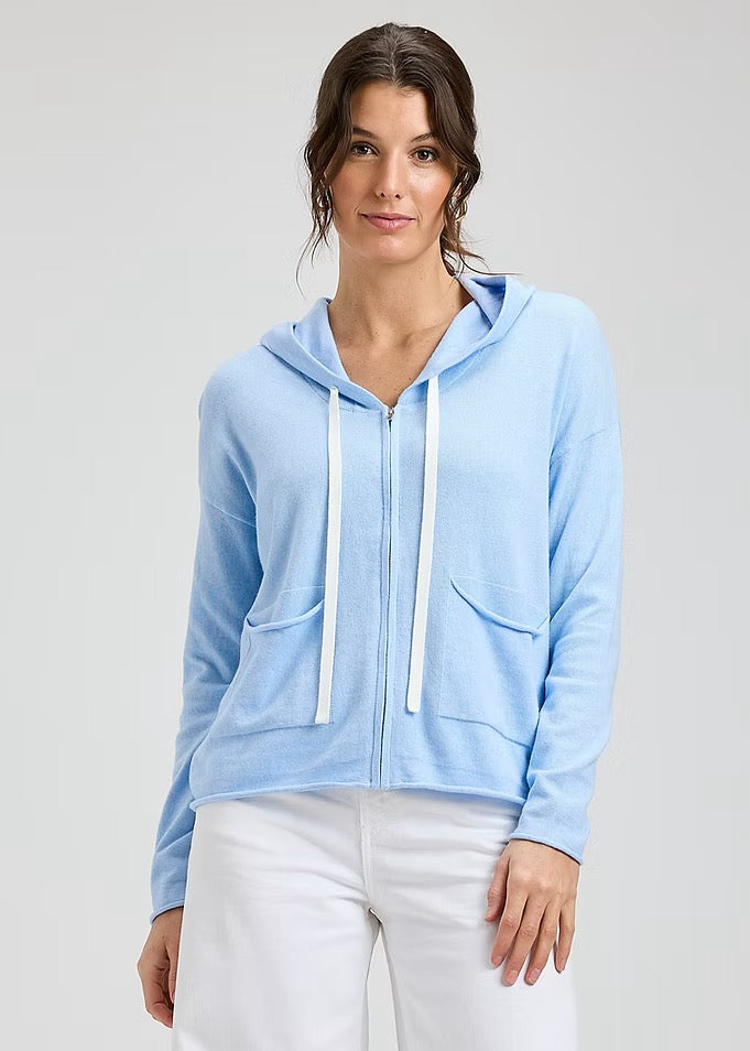 Powder blue boxy hoodie from Zaket & Plover, casual tops with a relaxed fit and long sleeves, displayed on a hanger.