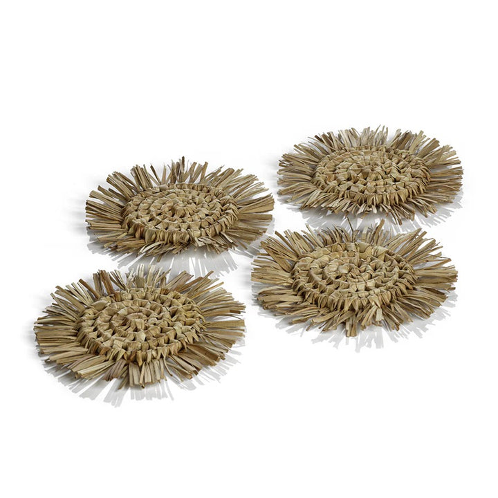 Set of four Zodax fringed coasters with textured fabric design, perfect for protecting surfaces in home decor.