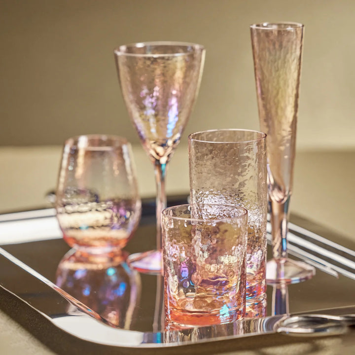 Pink Luster Highball Glass by Zodax for home use, showcasing a shiny, reflective surface and elegant tall design.