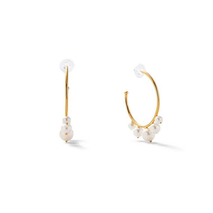 Small pearl swirl earrings from Catherine Canino, delicate silver accessories with elegant pearl accents.