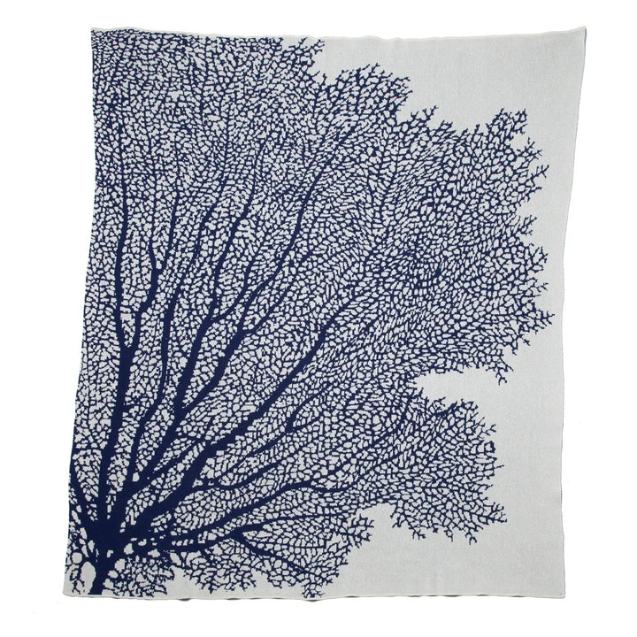 Soft coral throw blanket from In2Green, cozy home decor with textured fabric and vibrant coral color.