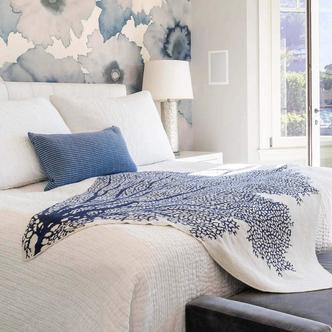 Soft coral throw blanket from In2Green, cozy home accessory with textured fabric, perfect for adding warmth and color to living spaces.
